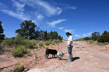 Young woman walks her dog on the rugged roads and trails at Toroweap in Grand Canyon National Park, Arizona.