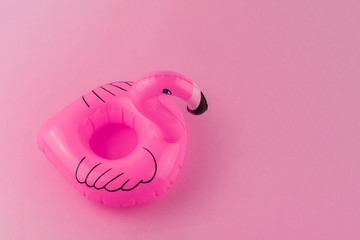 Pink floating Flamingo on pastel pink background. Summer minimal concept. 