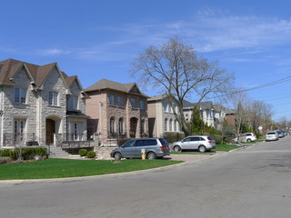 Obraz premium suburban street with modern large fabricated stone houses