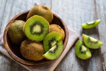 Peel and stick wall murals Dining Room Fresh kiwi fruit in the bowl on wooden background