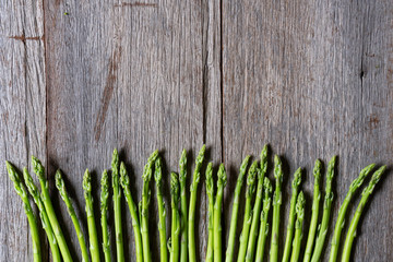 fresh asparagus on wooden background