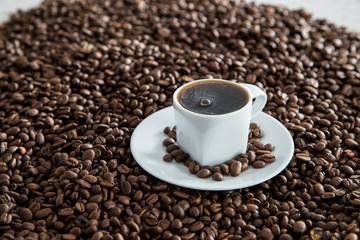 cup of coffee and beans on stone background