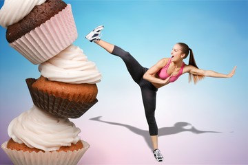 Fit young woman fighting off fast food