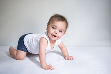 Blue-eyed baby in bed