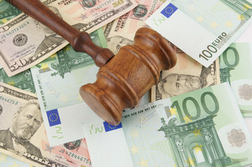 Judge gavel on dollar and euro banknotes background
