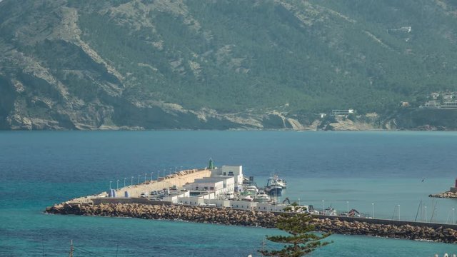 Commercial fishing vessel makes way as another fishing boat enters the harbour.