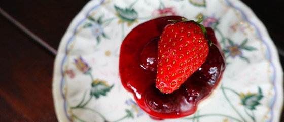 Strawberry jam with fresh berries on the plate