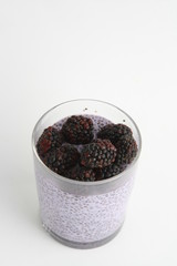 glass of chia pudding with blackberry flavor