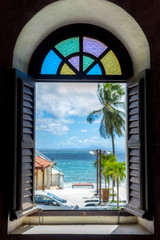 view from window on the Caribbean sea with beach and plam tree 