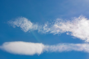 Fluffy white clouds on a blue sky background