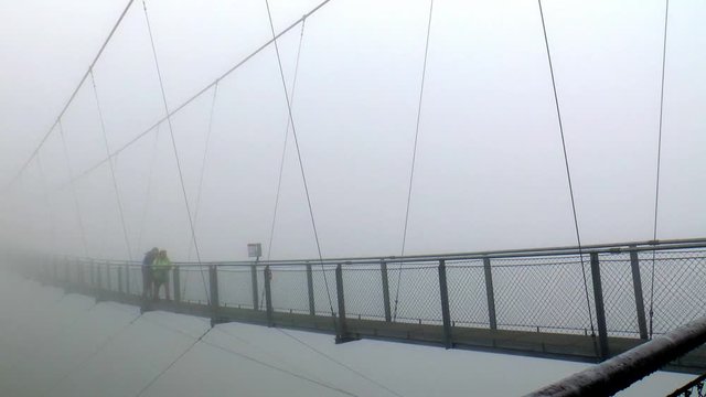 Walking across the highest suspension bridge in Europe in the fog.
The suspension bridge is located on the Stubnerkogel in Bad Gastein.