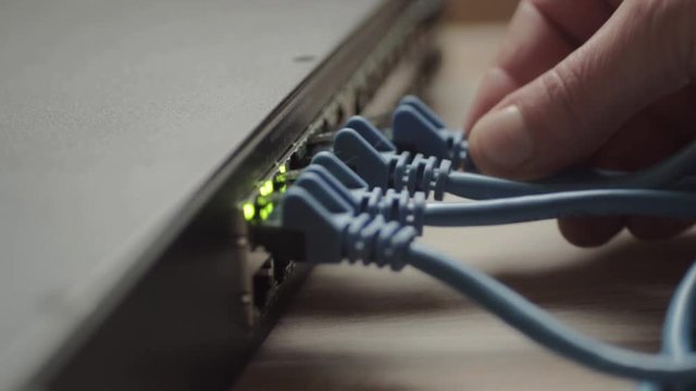 Network engineer working on Ethernet cable switch