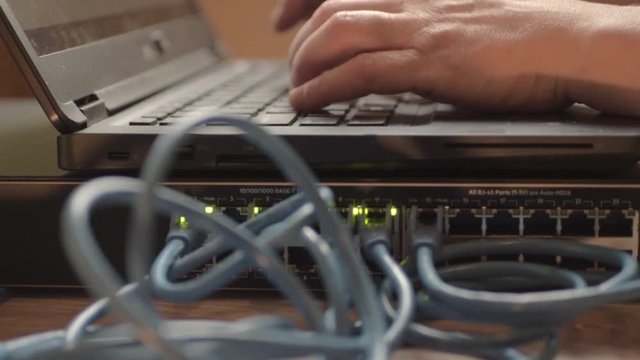 Network engineer working on Ethernet cable switch
