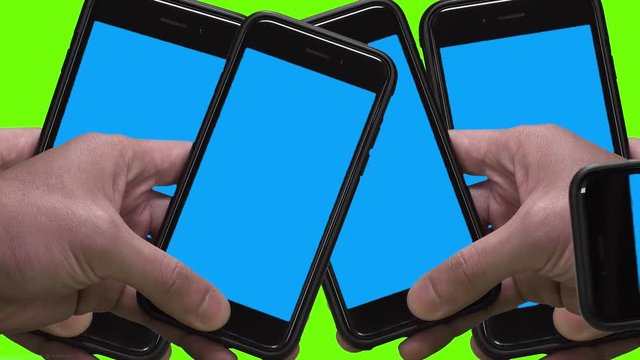 Close up shot of man`s hand holding black smartphone with blue background(chroma key) on screen. Many smartphone in vertical and horizontal position. Green background (chroma key).