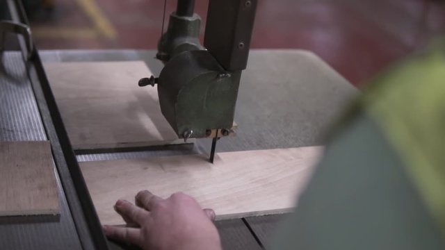 Man cutting wood with bandsaw 100fps slowed to 30%