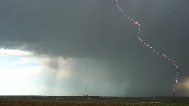 Spring lightning and thunderstorms over the plains of Wyoming, USA.  Long lightning strike.