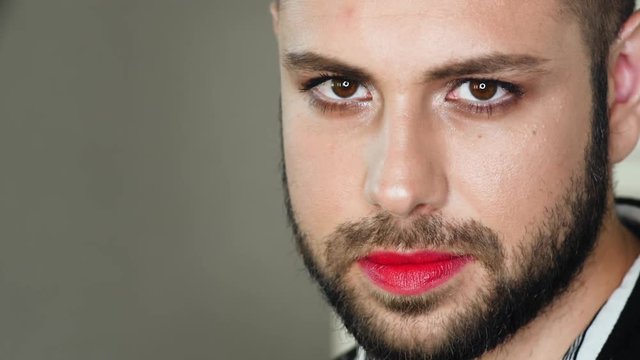 Portrait of bearded man with makeup