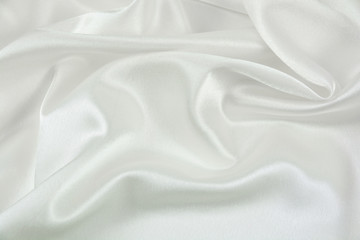 The texture of the satin fabric of white color for the background
