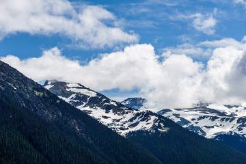Fototapeta premium alpine landscape view from Garibaldi provincial park with peaks covered by snow and clouds.