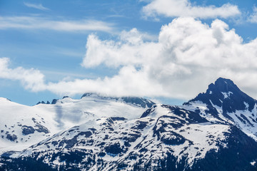 alpine landscape view from Garibaldi provincial park with peaks covered by snow and clouds.