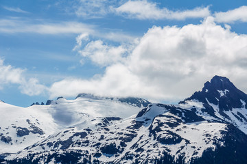 alpine landscape view from Garibaldi provincial park with peaks covered by snow and clouds.