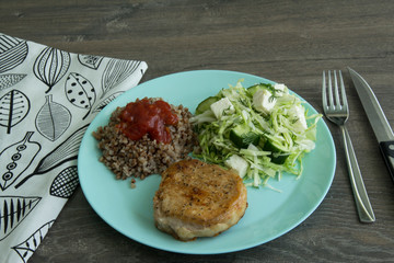 Medallion of pork, cabbage salad, pickle cheese and cucumbers, buckwheat with red sauce