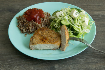 Medallion of pork, cabbage salad, pickle cheese and cucumbers, buckwheat with red sauce