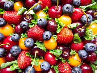 background of fresh cherries, strawberries, blueberry and physalis