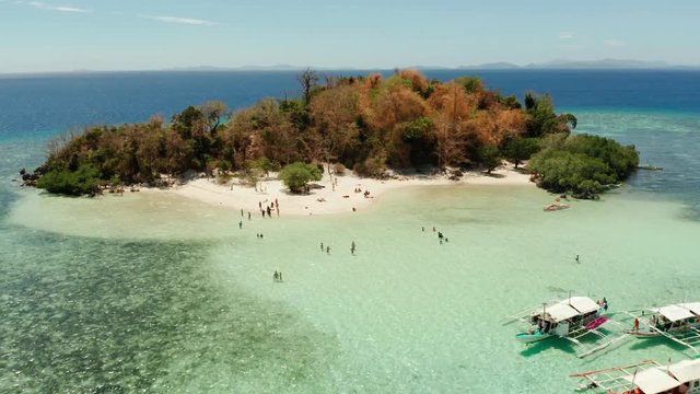 aerial seascape tourists enjoy tropical beach. tropical island with sand beach CYC, palm trees. Philippines, Palawan. Tropical landscape with blue lagoon, coral reef