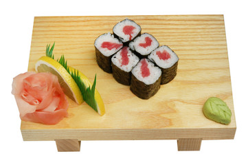 Sushi on a wooden stand, wasabi and pickled ginger. On white isolated background