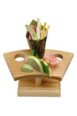 Mix of vegetables and seafood on a wooden stand, wasabi and pickled ginger. On white isolated background