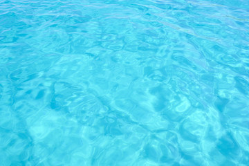 Close-up view of a transparent turquoise sea water that forms a natural texture, Emerald Coast, Sardinia, Italy.