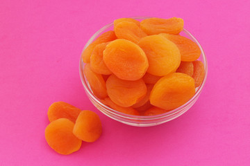 Dried apricots fruits on pink background