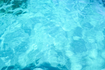 Close-up view of a transparent turquoise sea water that forms a natural texture, Emerald Coast, Sardinia, Italy.