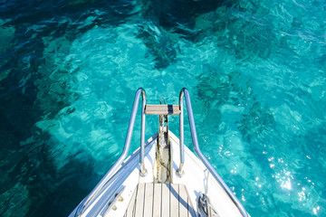 (Selective focus) Stunning view of a bow of a yacht sailing on a beautiful turquoise and...