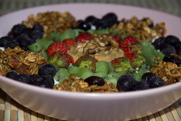Cottage cheese with granola, kiwi, strawberries, blueberries