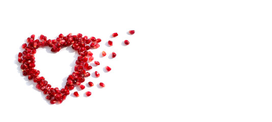 pomegranate seeds scattered in the shape of a heart