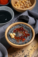 Black hummus with black sesame tahini.  Traditional middle eastern appetizer. Trendy food, healthy vegan food.