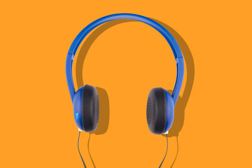 blue headphones isolated on orange background