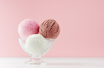 Tasty fresh set of ice cream - strawberry, chocolate, creamy in glass bowl on white wooden table...