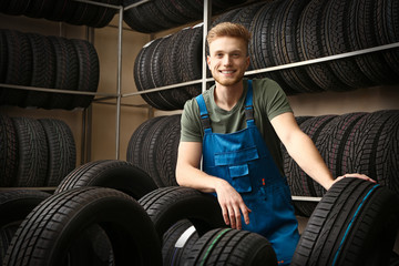 Male seller in car tire store