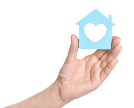 Female hand with figure of house on white background. Mortgage concept