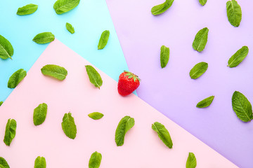 Sweet ripe strawberry and mint leaves on color background