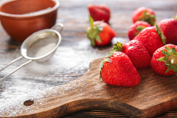 Sweet ripe strawberry on wooden board