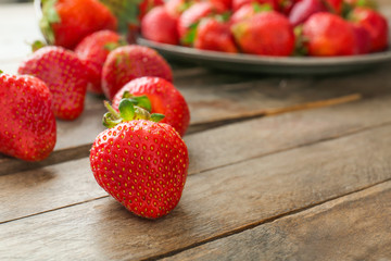 Sweet ripe strawberry on wooden background