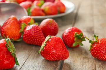 Sweet ripe strawberry on wooden background