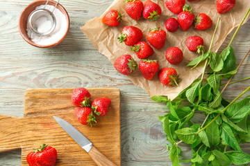 Composition with ripe strawberry on wooden background