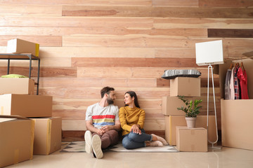 Young couple with belongings after moving into new house