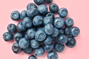 Heap of ripe blueberry on color background