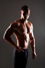 Fototapeta na wymiar Strong, fit and sporty bodybuilder man over black background.